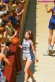 A group of young women playing a game of basketball.